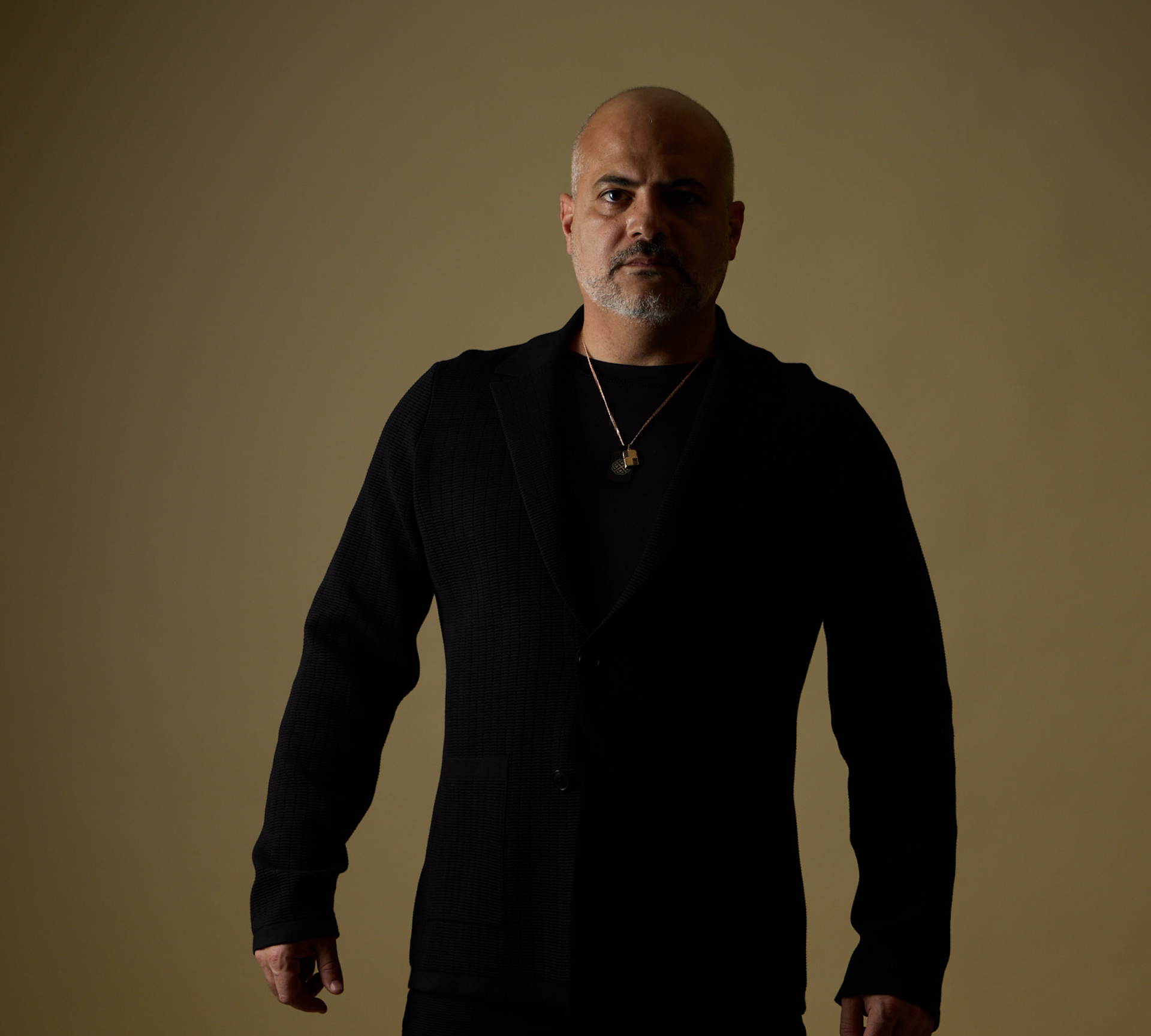 Gaston Rivero editorial portrait on olive backdrop